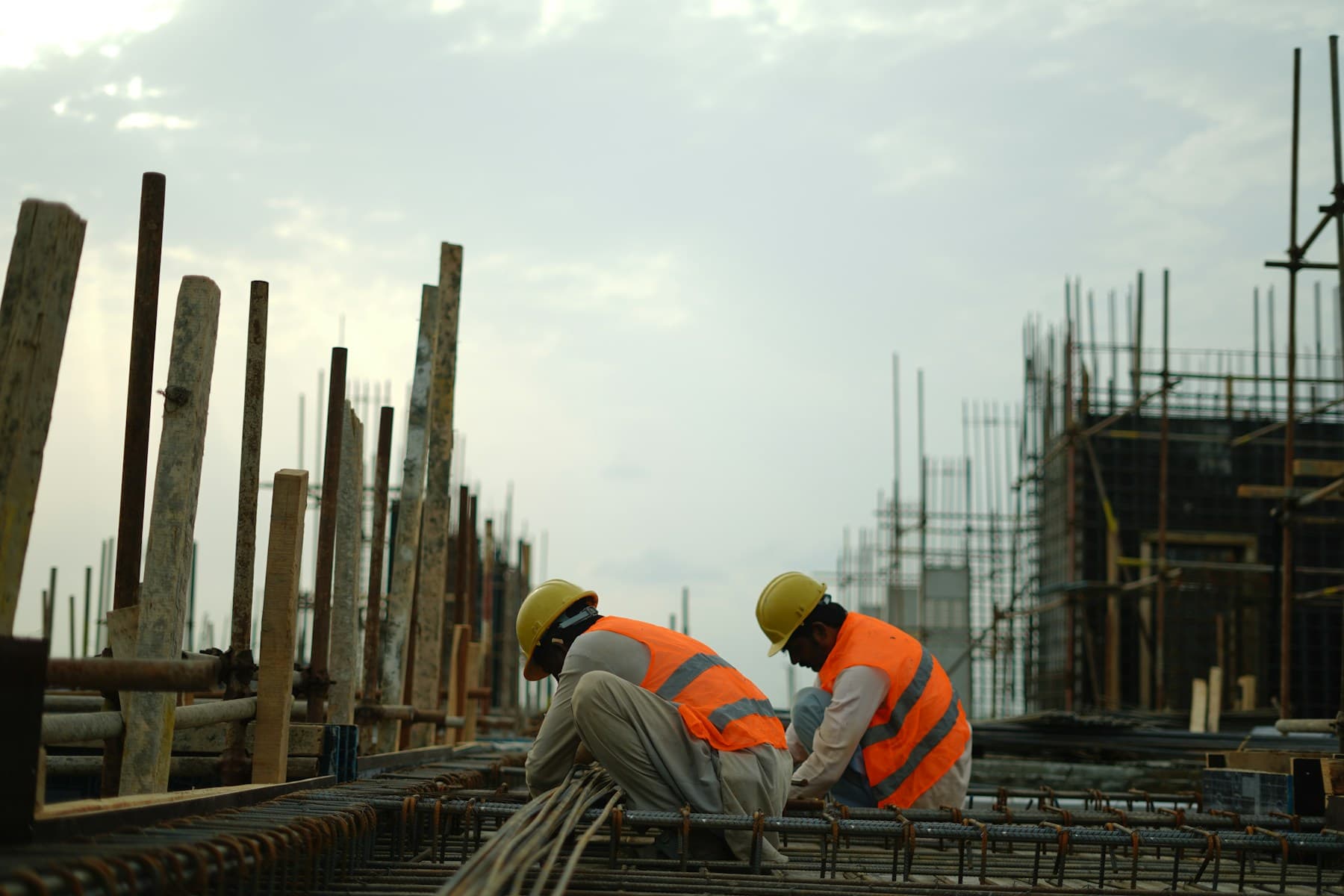 Construction operatives in high visibility workwear on an active building site